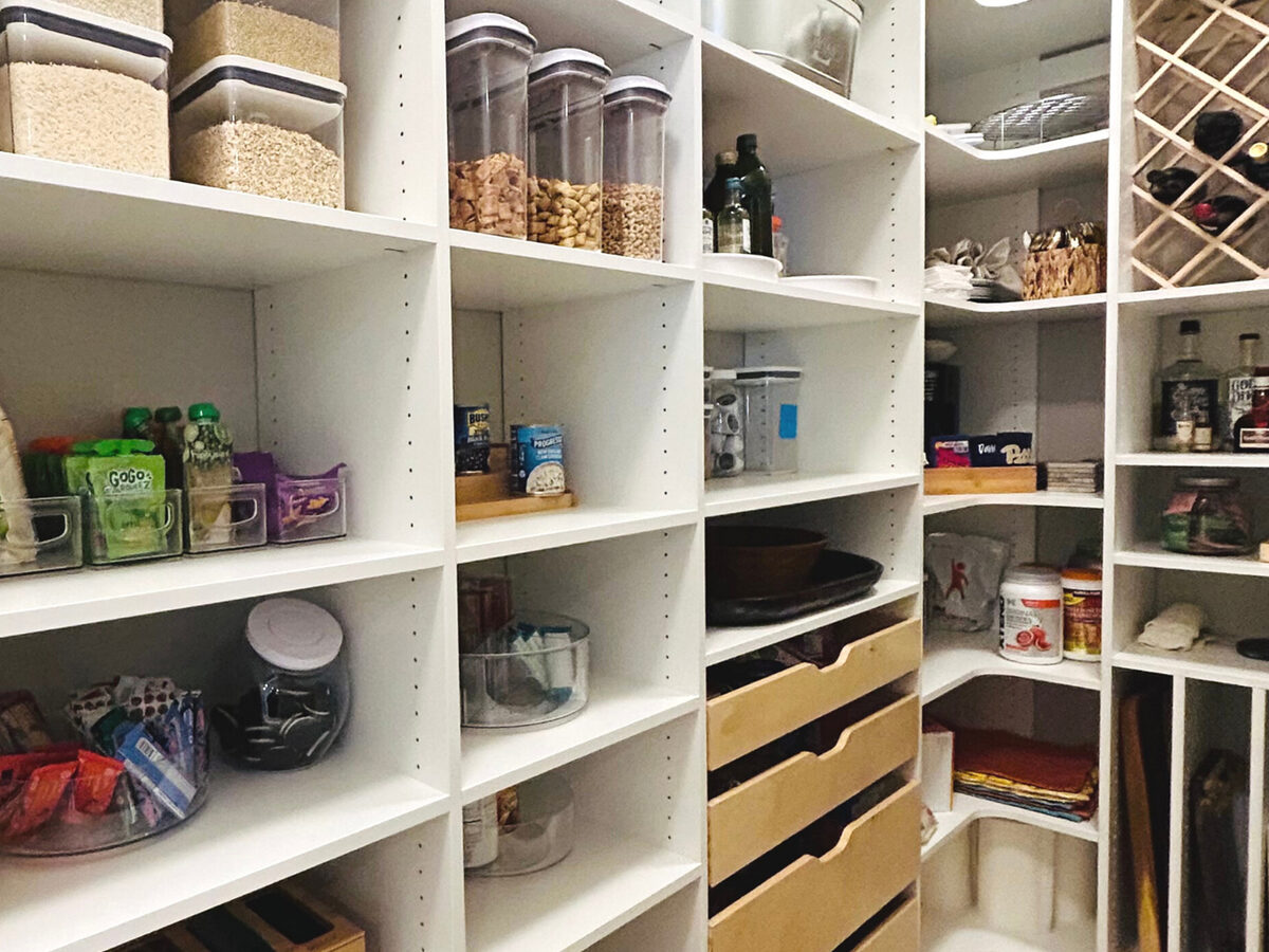 Custom pantry with pull-out drawers and open shelving