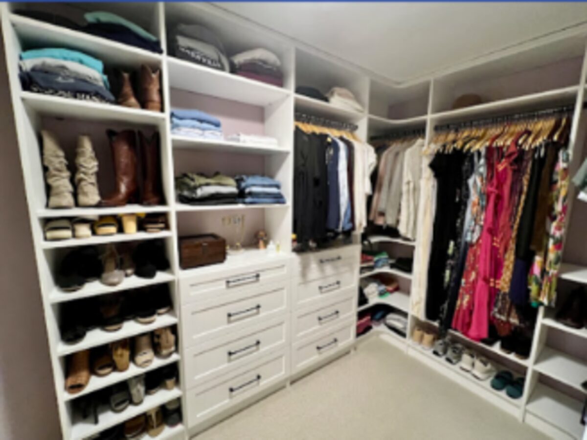 White custom closet shelving with drawers and hanging space